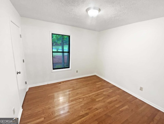 2325 Sebring Ct SW, Marietta, GA 30064 - unfurnished room with a textured ceiling, wood finished floors, and baseboards
