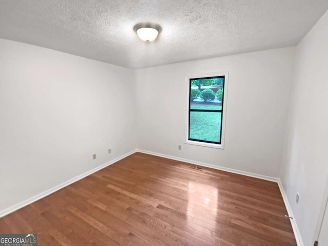 2325 Sebring Ct SW, Marietta, GA 30064 - unfurnished room featuring wood finished floors, a textured ceiling, and baseboards