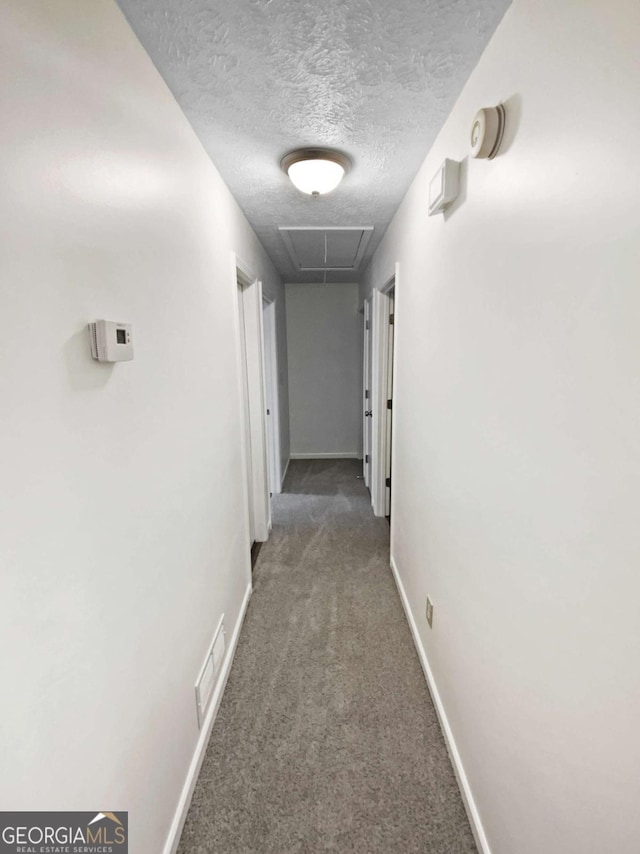 2325 Sebring Ct SW, Marietta, GA 30064 - hall with attic access, carpet, a textured ceiling, and baseboards