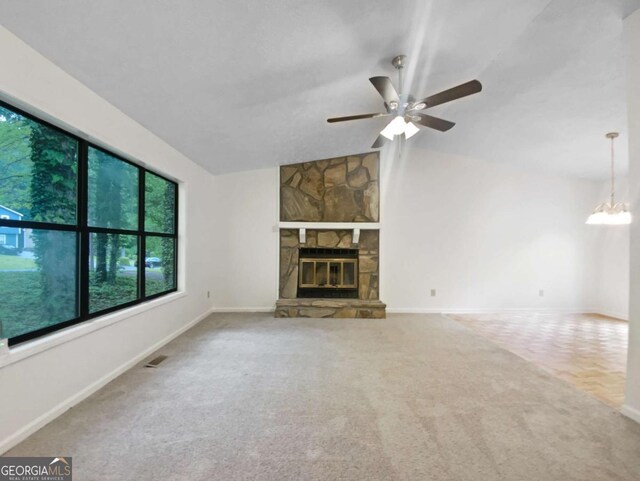 2325 Sebring Ct SW, Marietta, GA 30064 - unfurnished living room featuring carpet flooring, ceiling fan, lofted ceiling, a stone fireplace, and baseboards