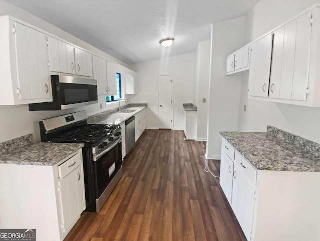2325 Sebring Ct SW, Marietta, GA 30064 - kitchen with stainless steel appliances, dark wood-style floors, a sink, and white cabinets