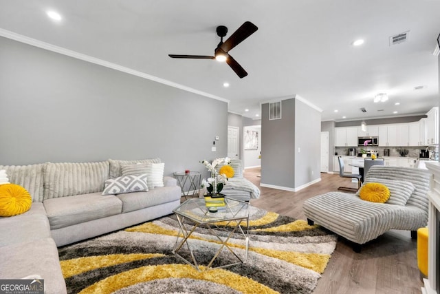 1892 Ivy View Walk, Loganville, GA 30052 - living room featuring recessed lighting, ornamental molding, ceiling fan, light wood-type flooring, and baseboards