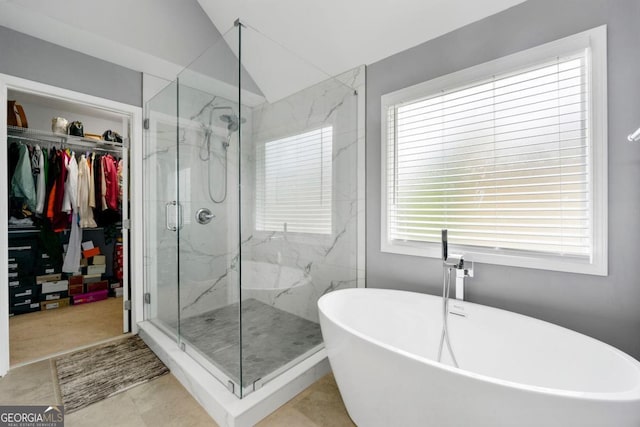 1892 Ivy View Walk, Loganville, GA 30052 - full bathroom featuring a marble finish shower, a walk in closet, a soaking tub, and vaulted ceiling