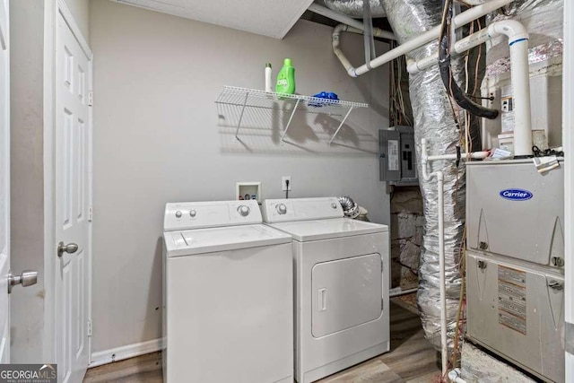 2025 Venetian Dr SW, Atlanta, GA 30311 - washroom featuring washing machine and dryer, electric panel, and wood finished floors