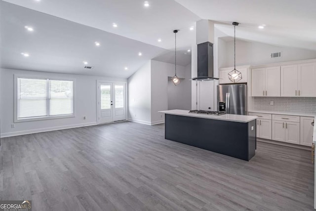 2265 Hillbriar Dr, Buford, GA 30518 - kitchen with stainless steel appliances, exhaust hood, a kitchen island, light countertops, and white cabinets