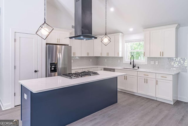2265 Hillbriar Dr, Buford, GA 30518 - kitchen featuring a sink, stainless steel appliances, island exhaust hood, white cabinetry, and lofted ceiling