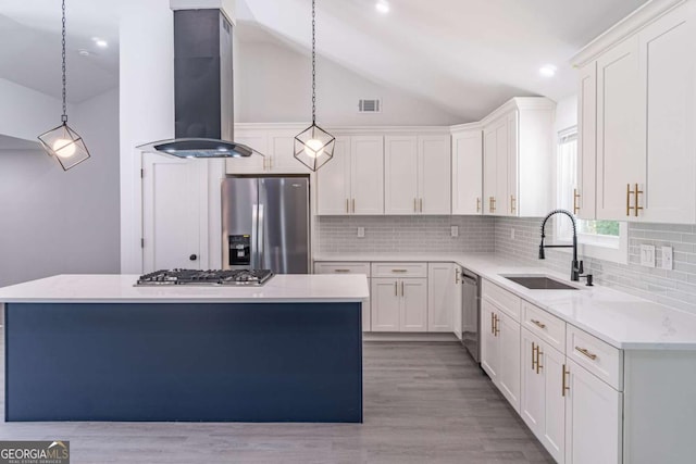 2265 Hillbriar Dr, Buford, GA 30518 - kitchen featuring appliances with stainless steel finishes, exhaust hood, a sink, vaulted ceiling, and a center island