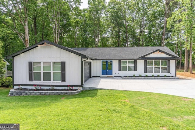 2265 Hillbriar Dr, Buford, GA 30518 - view of front of home with a front lawn, an attached garage, a shingled roof, and view of scattered trees