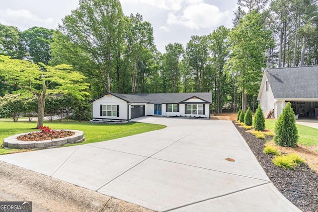 2265 Hillbriar Dr, Buford, GA 30518 - ranch-style house with concrete driveway, a front yard, an attached garage, and view of scattered trees