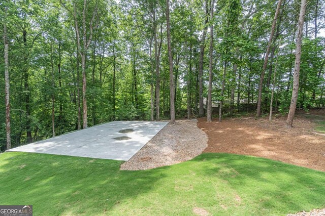 2265 Hillbriar Dr, Buford, GA 30518 - view of sport court featuring a yard and a view of trees