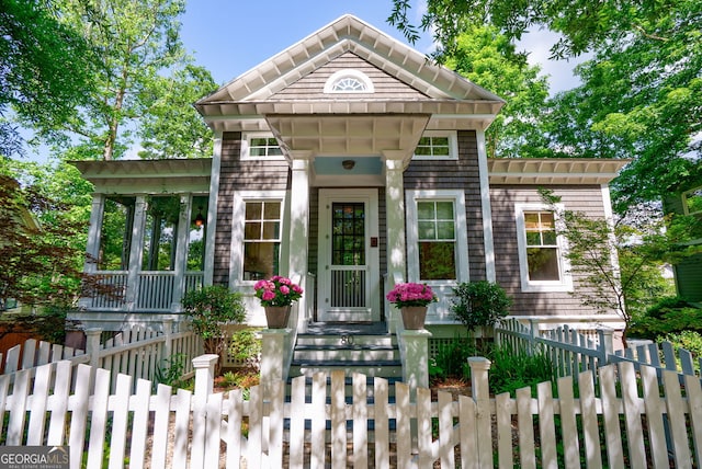 view of front facade with a fenced front yard and a tile roof