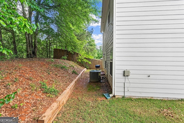 view of side of property with fence and central air condition unit