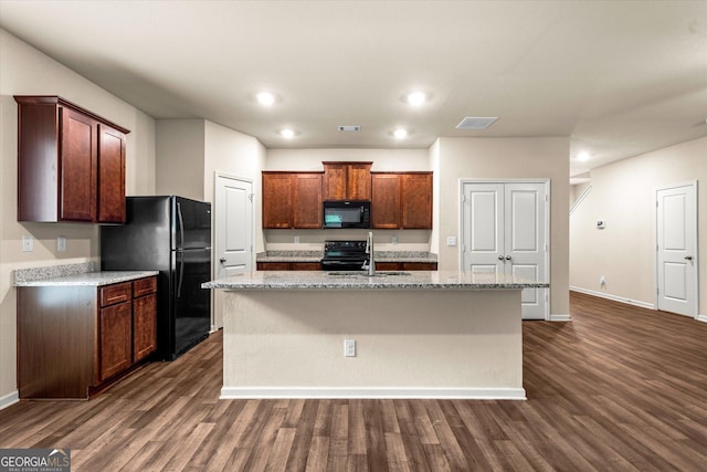 kitchen featuring black appliances, baseboards, dark wood-type flooring, a kitchen island with sink, and a sink