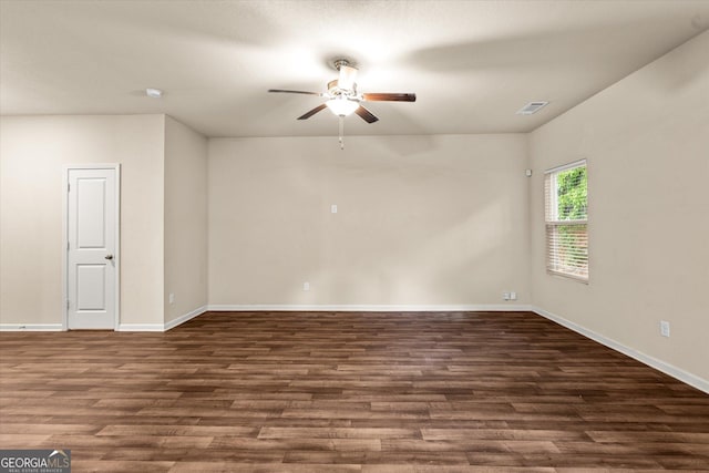spare room with ceiling fan, wood finished floors, baseboards, and a smoke detector