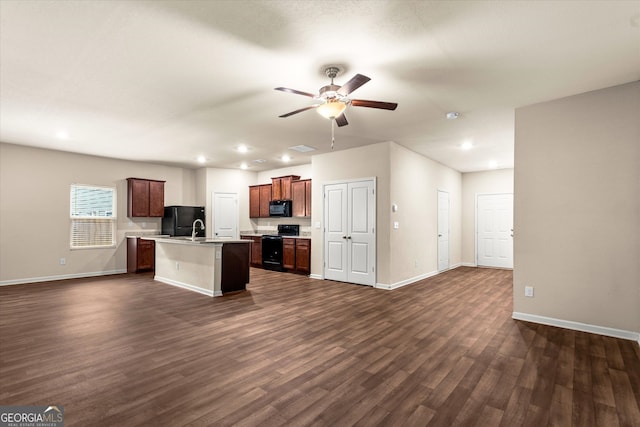 kitchen with black appliances, open floor plan, baseboards, and recessed lighting