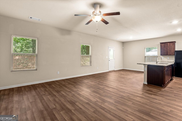 unfurnished living room featuring ceiling fan, a sink, dark wood-style flooring, recessed lighting, and baseboards