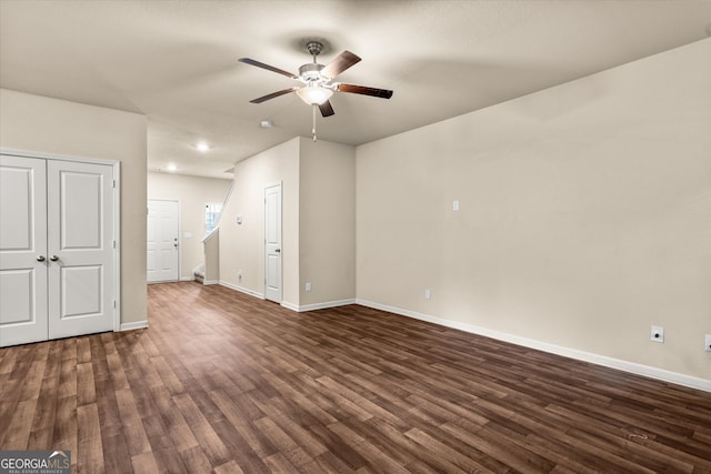 unfurnished living room with a ceiling fan, baseboards, dark wood-style floors, recessed lighting, and stairs