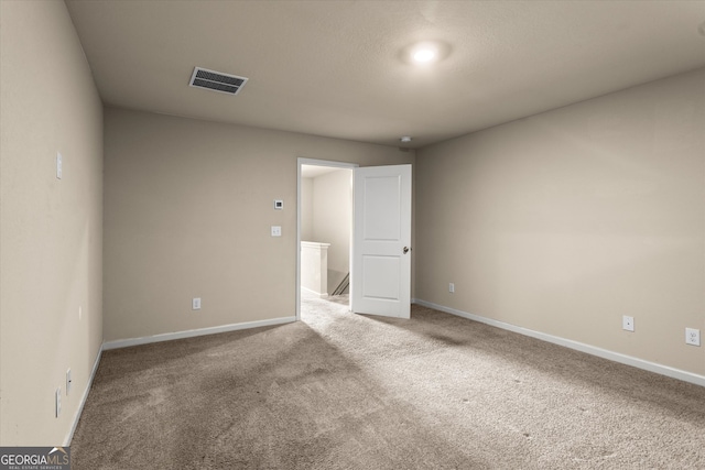 unfurnished bedroom with carpet flooring and baseboards