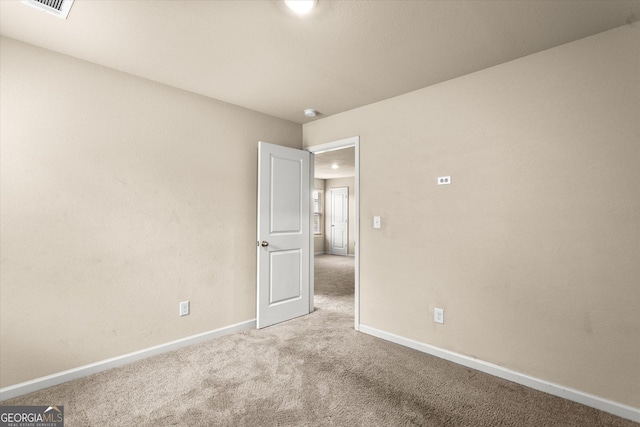 carpeted empty room with baseboards