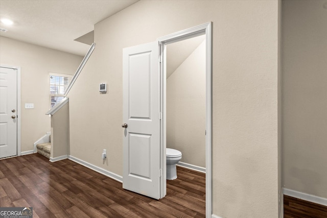 bathroom with wood finished floors, toilet, and baseboards