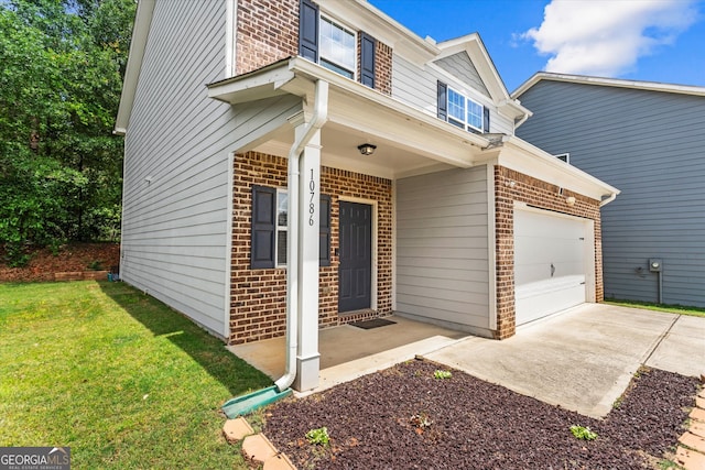 view of front facade with brick siding, a garage, a front lawn, driveway, and covered porch