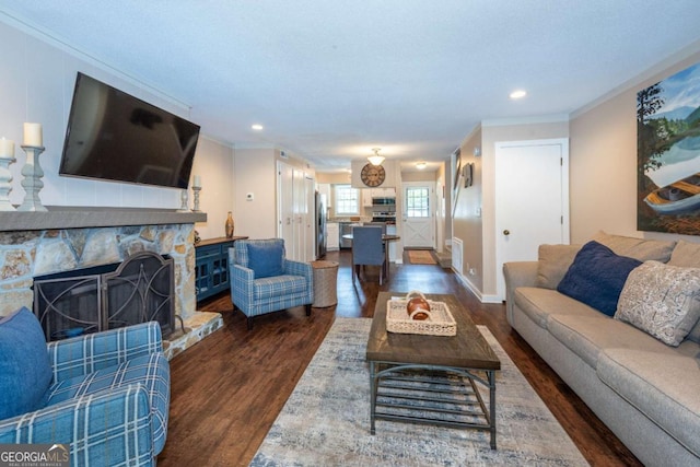 living area featuring dark wood-style flooring, crown molding, a fireplace, recessed lighting, and baseboards