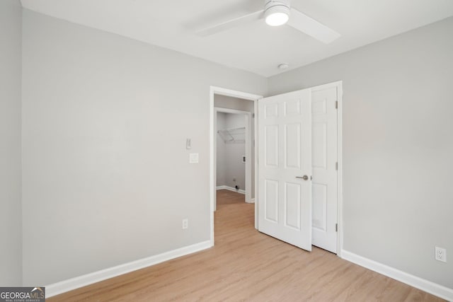 unfurnished bedroom with wood finished floors, baseboards, and ceiling fan