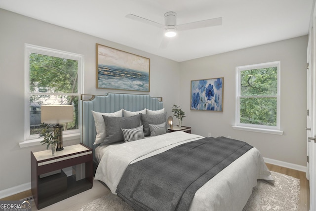 bedroom featuring wood finished floors, baseboards, and ceiling fan