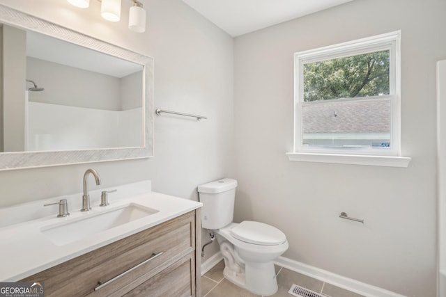 bathroom with baseboards, toilet, tile patterned floors, and vanity