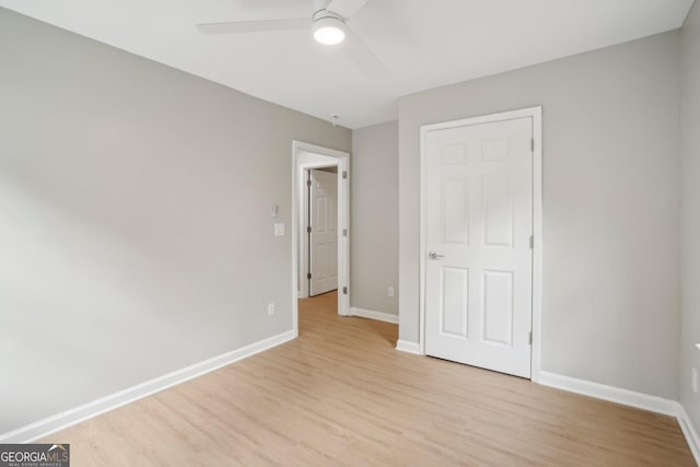 unfurnished bedroom featuring light wood-style floors, baseboards, and ceiling fan