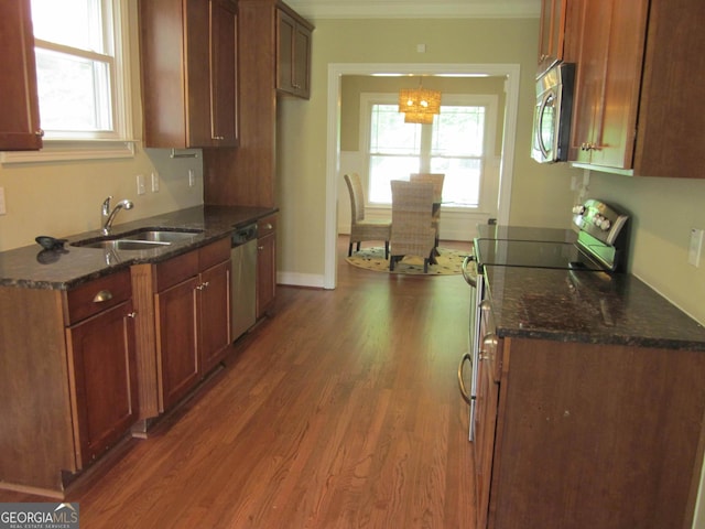 1527 Princeton Ave, College Park, GA 30337 - kitchen featuring appliances with stainless steel finishes, a sink, crown molding, wood finished floors, and dark stone counters