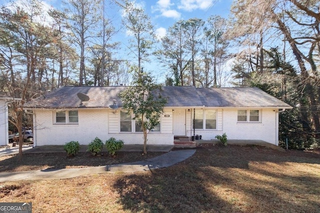 single story home with brick siding and a front lawn