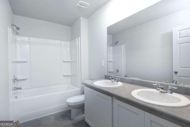 bathroom featuring toilet, shower / bathtub combination, and double vanity