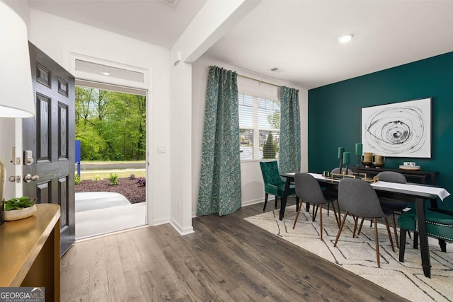 dining room featuring wood finished floors, baseboards, and recessed lighting