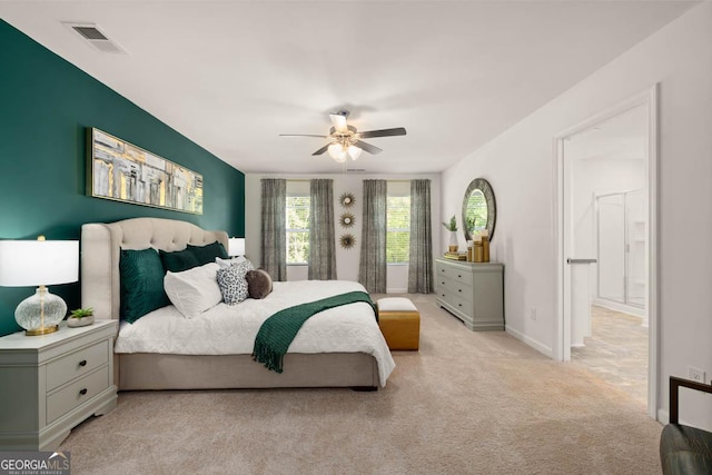 bedroom with light colored carpet, a ceiling fan, and baseboards