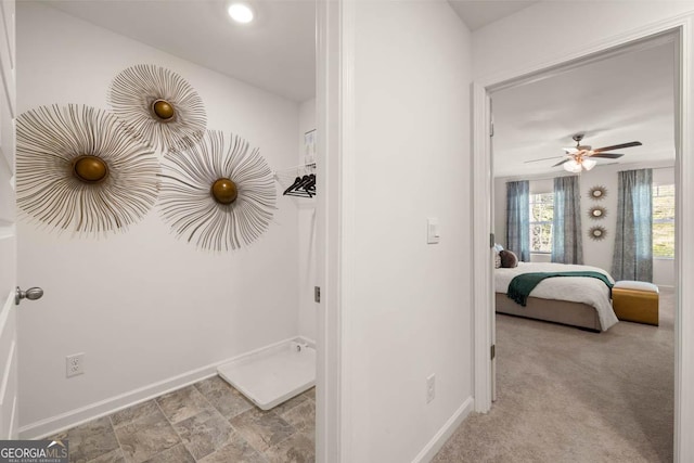 hallway featuring baseboards