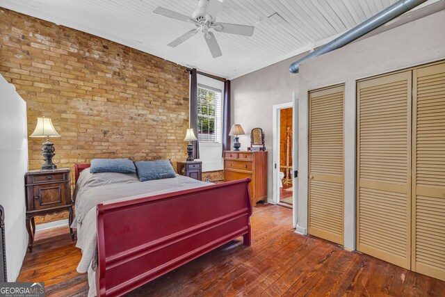 1 Public Sq, Bowman, GA 30624 - bedroom with brick wall, multiple closets, wood-type flooring, and a ceiling fan