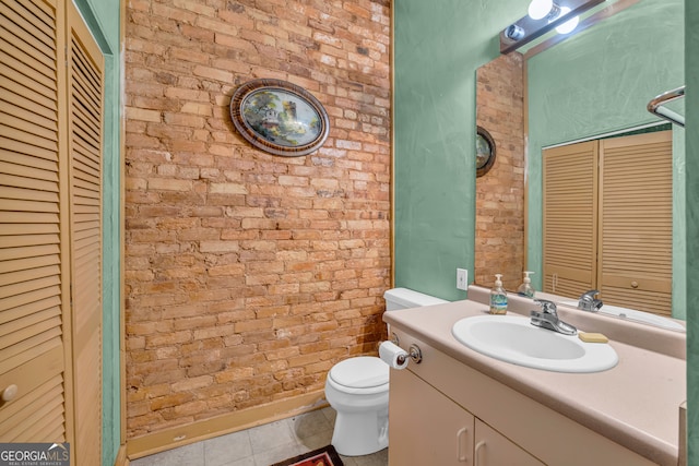 1 Public Sq, Bowman, GA 30624 - bathroom with a closet, brick wall, tile patterned floors, toilet, and vanity