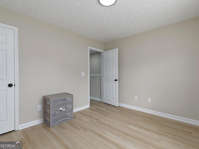 201 Twin Pines Ct, Dallas, GA 30132 - unfurnished bedroom featuring light wood-style flooring, baseboards, and a textured ceiling