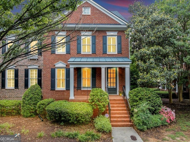 5000 Davenport Pl, Roswell, GA 30075 - colonial house with brick siding, covered porch, a standing seam roof, and metal roof