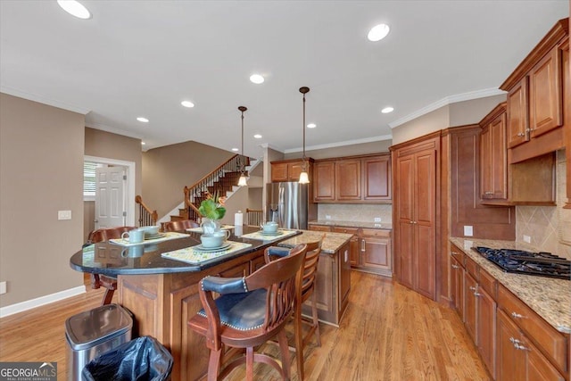 5000 Davenport Pl, Roswell, GA 30075 - kitchen featuring stainless steel fridge with ice dispenser, a kitchen breakfast bar, brown cabinets, light wood-style flooring, and crown molding