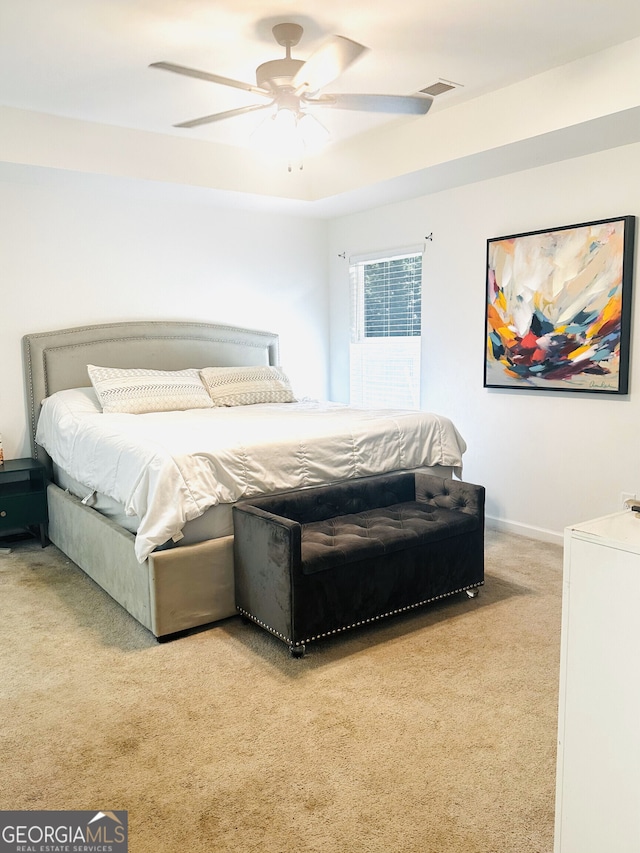 carpeted bedroom with ceiling fan and baseboards