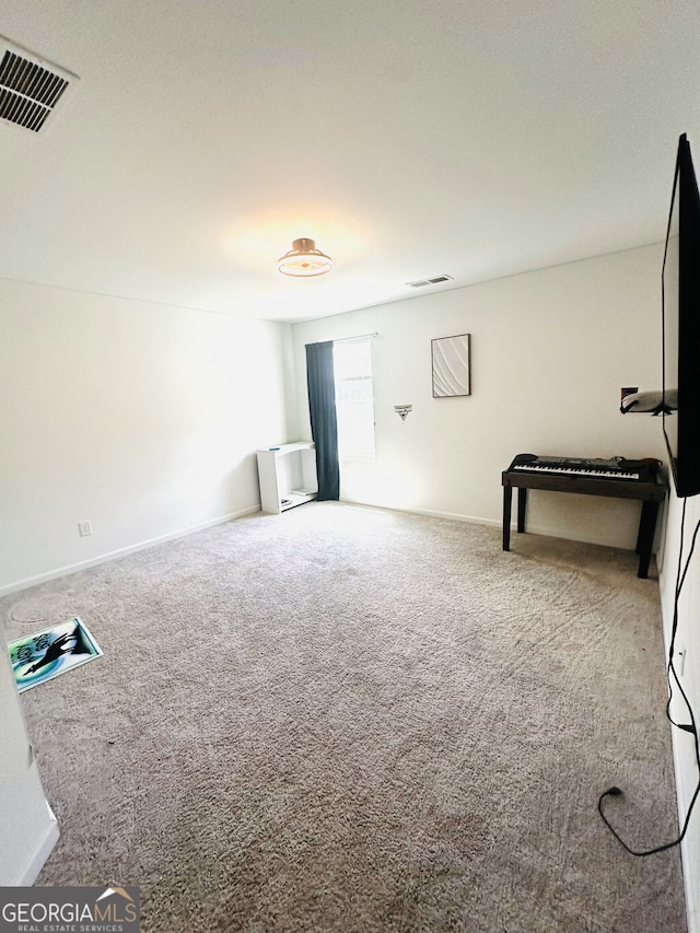 unfurnished living room featuring carpet flooring