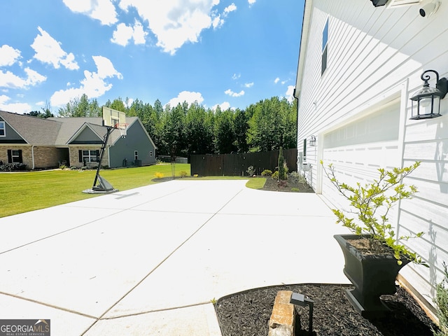 view of patio featuring concrete driveway and a garage