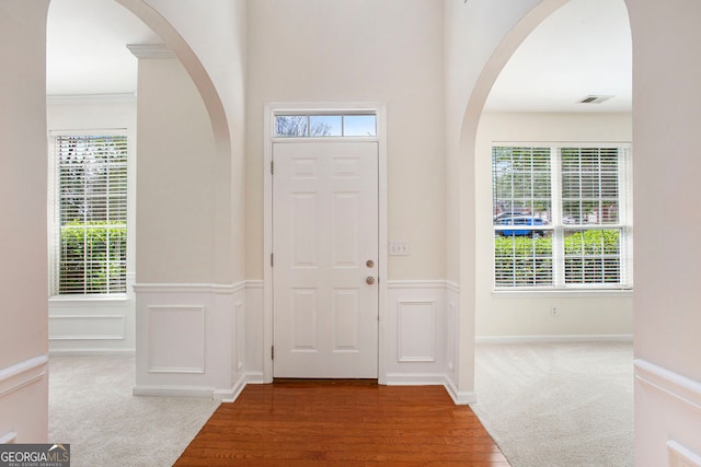 4535 Howell Farms Rd NW, Acworth, GA 30101 - carpeted foyer featuring healthy amount of natural light, arched walkways, a wainscoted wall, wood finished floors, and ornamental molding