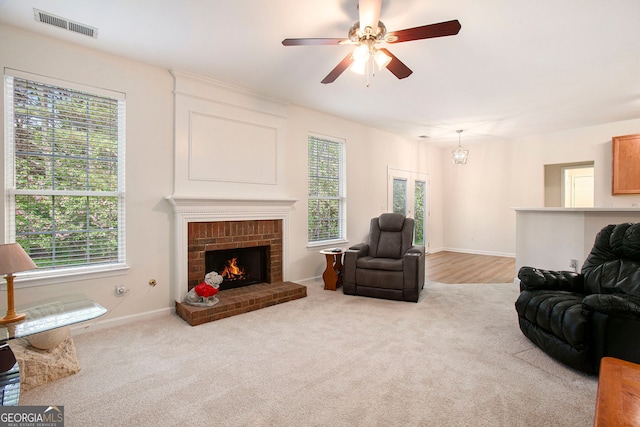4535 Howell Farms Rd NW, Acworth, GA 30101 - carpeted living room with ceiling fan, a brick fireplace, and baseboards