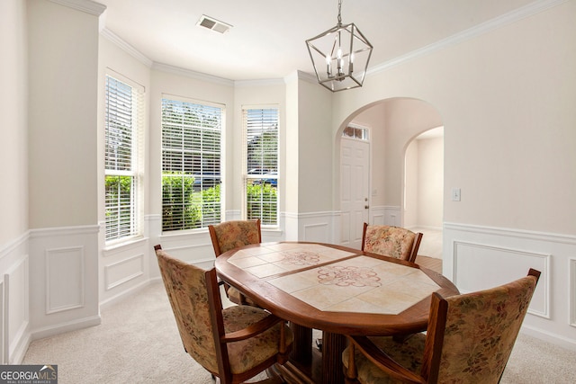 4535 Howell Farms Rd NW, Acworth, GA 30101 - dining room featuring a chandelier, light colored carpet, a wainscoted wall, a decorative wall, and arched walkways