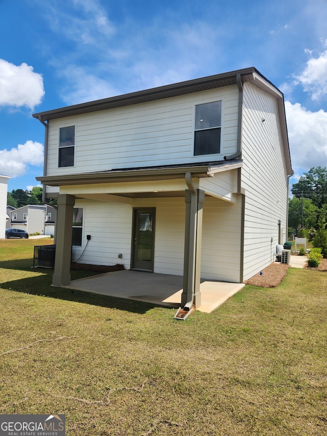 rear view of house featuring a patio area and a yard