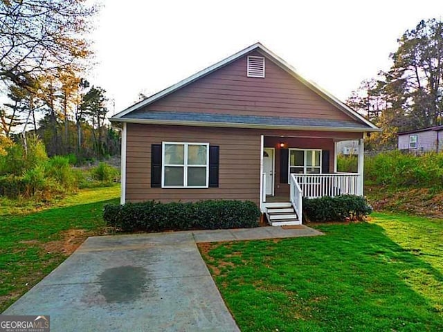 bungalow-style home with a porch and a front lawn