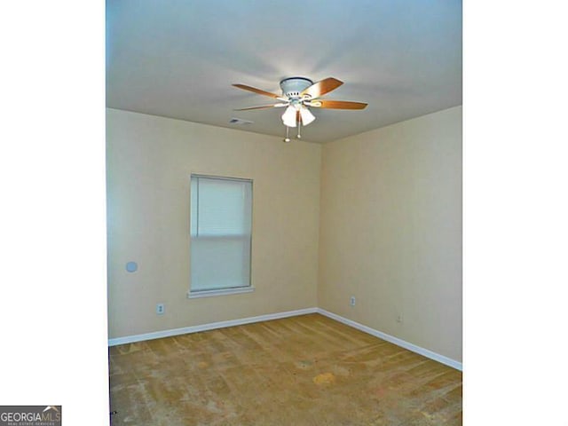unfurnished room with a ceiling fan, baseboards, and carpet floors